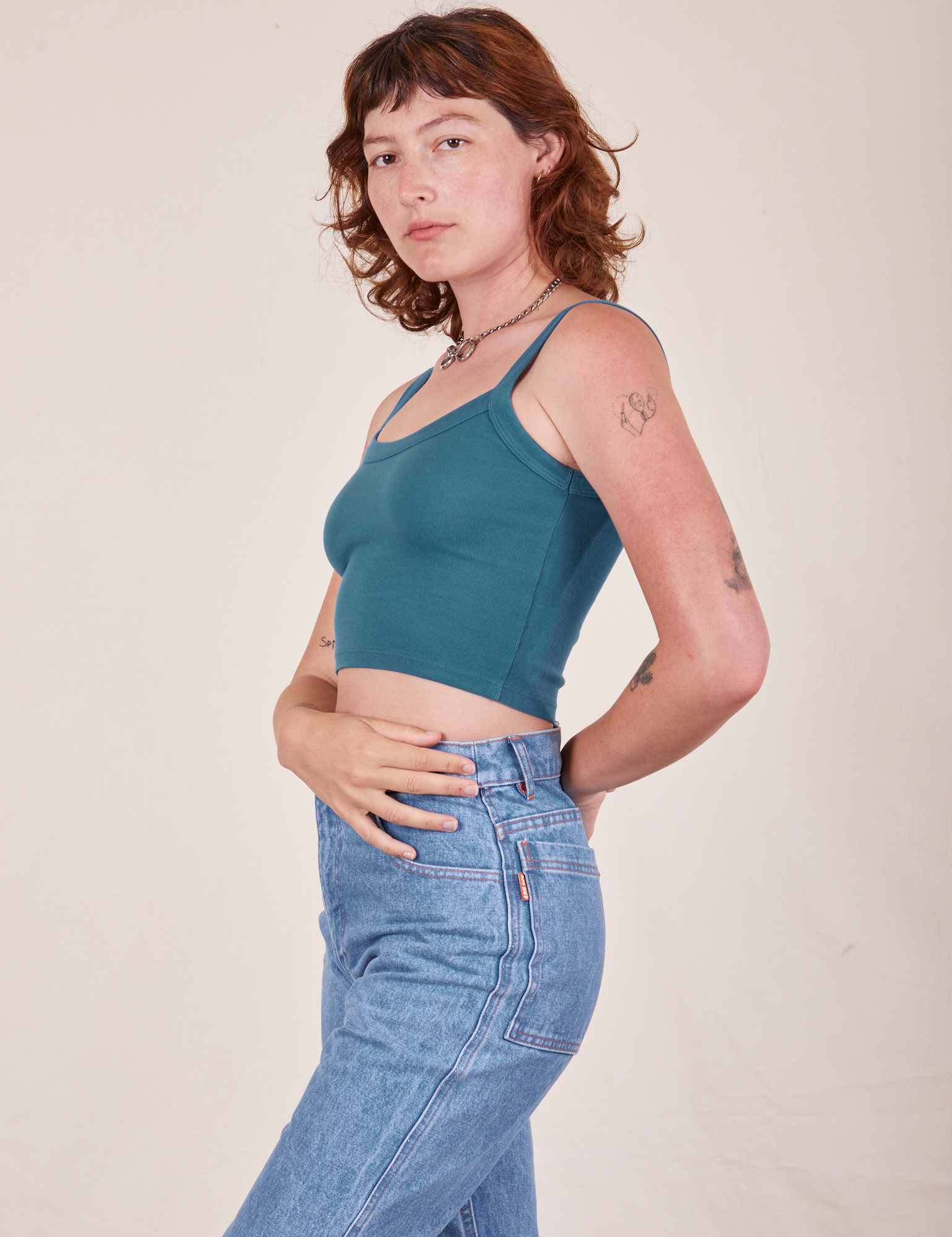 Side view of Cropped Cami in Marine Blue and light wash Frontier Jeans worn by Alex