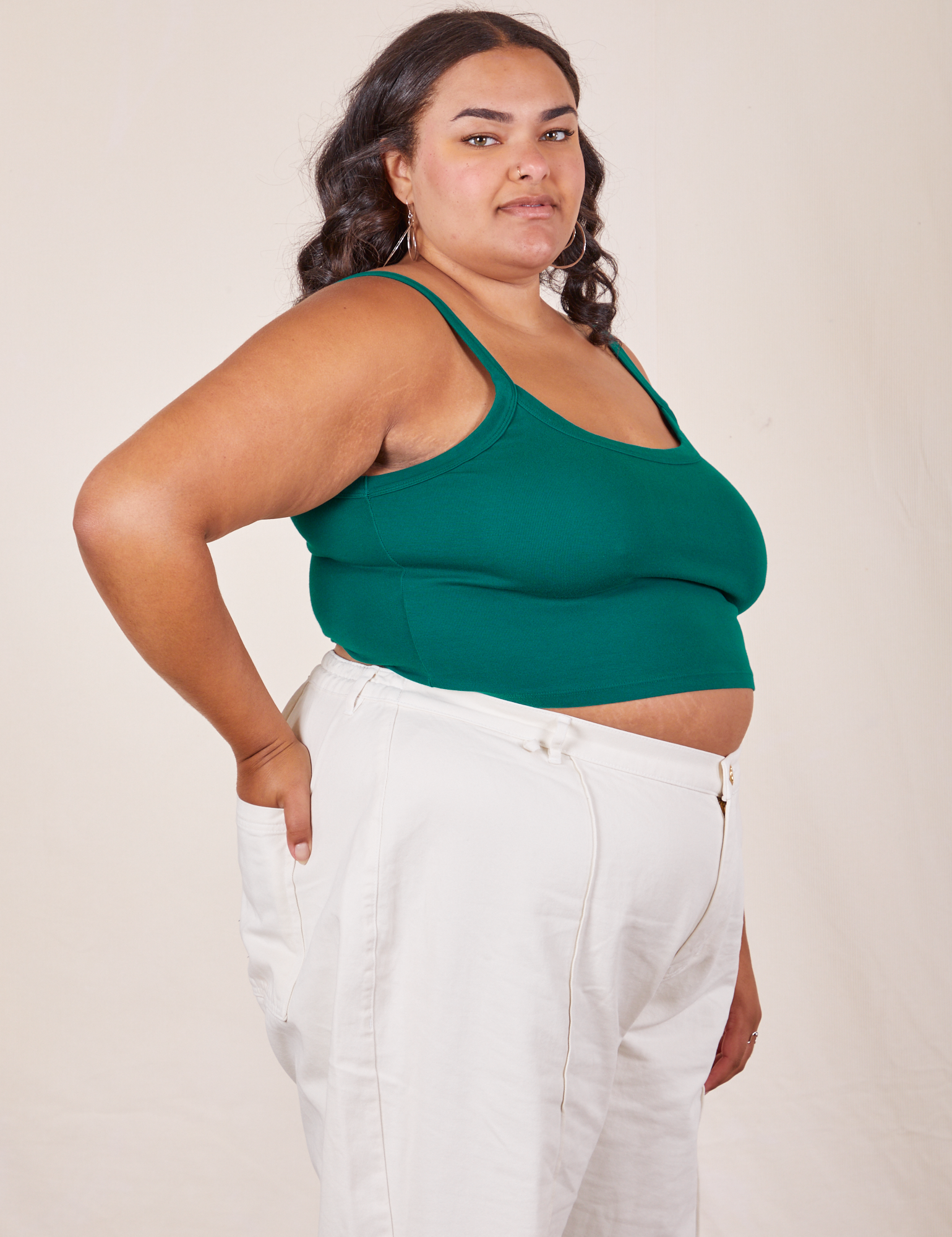 Angled view of Cropped Cami in Hunter Green and vintage tee off-white Western Pants worn by Alicia