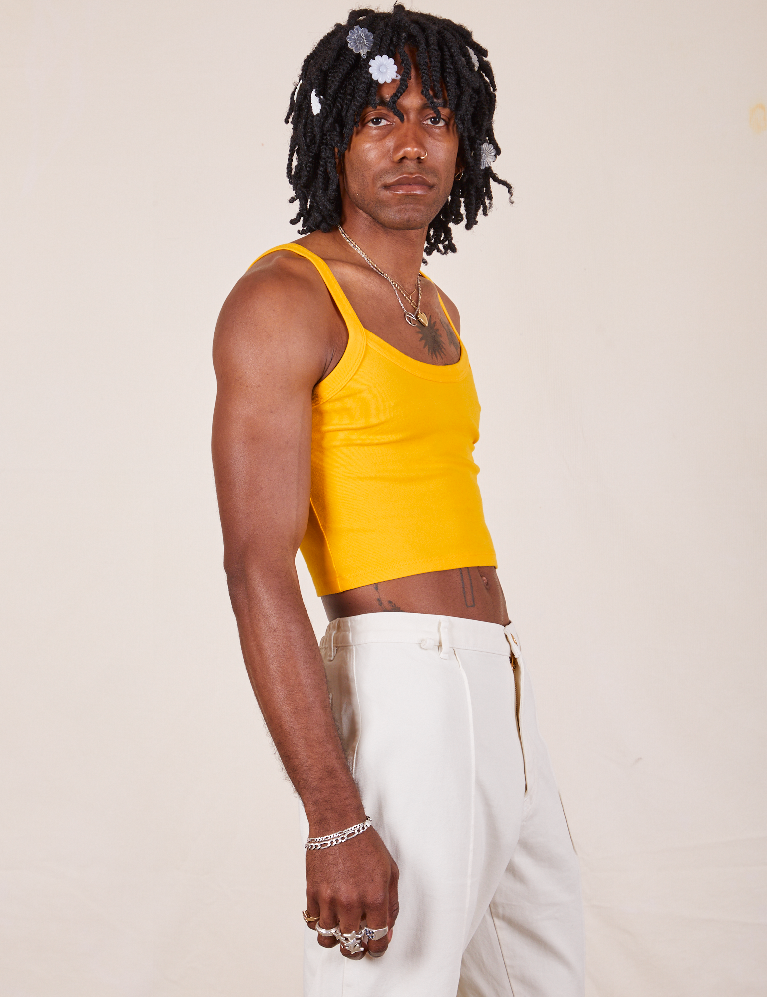 Side view of Cropped Cami in Sunshine Yellow and vintage tee off-white Western Pants worn by Jerrod