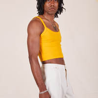 Side view of Cropped Cami in Sunshine Yellow and vintage off-white Western Pants worn by Jerrod