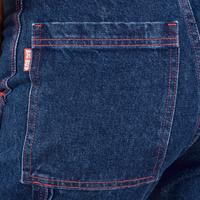 Carpenter Jeans in Dark Wash back pocket close up. Red contrast stitching on pocket and near seams.