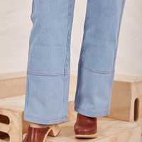 Pant leg close up of Carpenter Jeans in Light Wash worn by Tiara