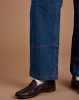 Carpenter Jeans in Dark Wash pant leg close up on Quinn