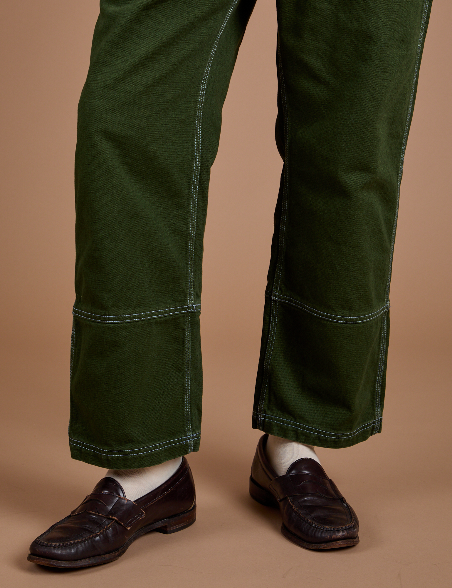Carpenter Jeans in Evergreen pant leg close up on Quinn