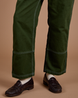 Carpenter Jeans in Evergreen pant leg close up on Quinn