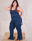 Carpenter Overalls in Dark Wash angled front view worn by Ashley