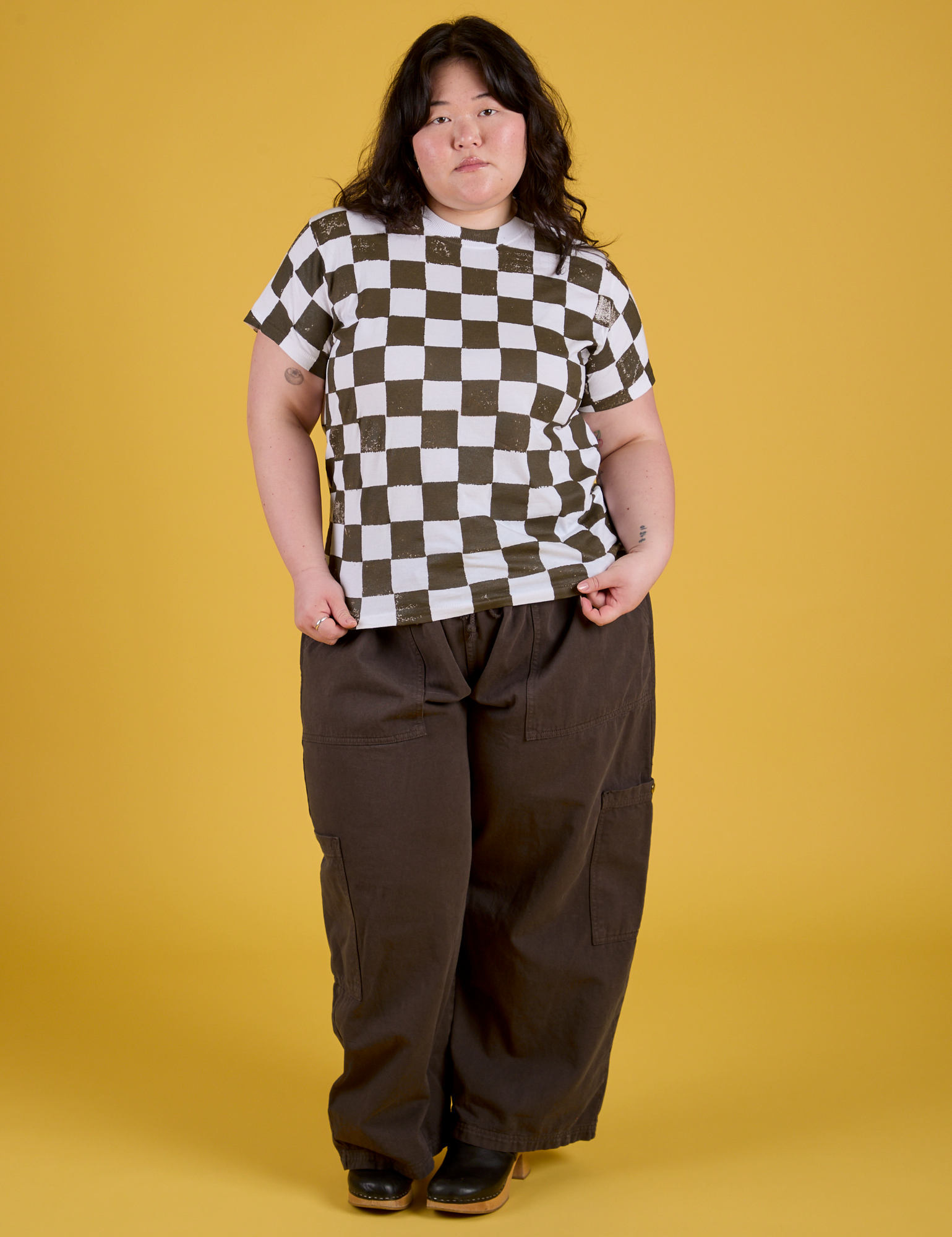Ashley is wearing Checker Organic Tee in Espresso Brown and Drop Pocket Cargo Pants in Espresso Brown