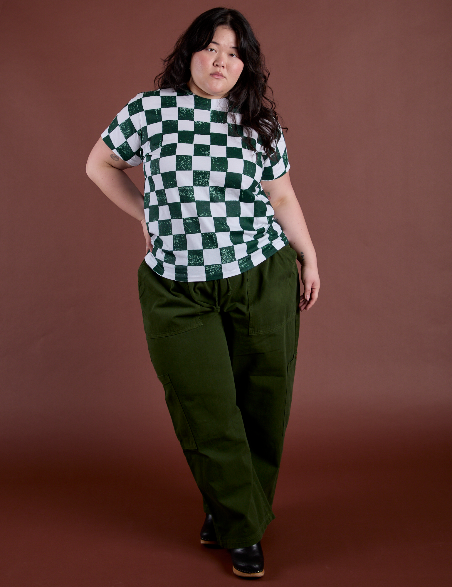 Ashley is wearing Checker Organic Tee in Swamp Green and evergreen Drop Pocket Cargo Pants