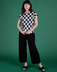 Alex is wearing Checker Organic Tee in Black and black Drop Pocket Cargo Pants