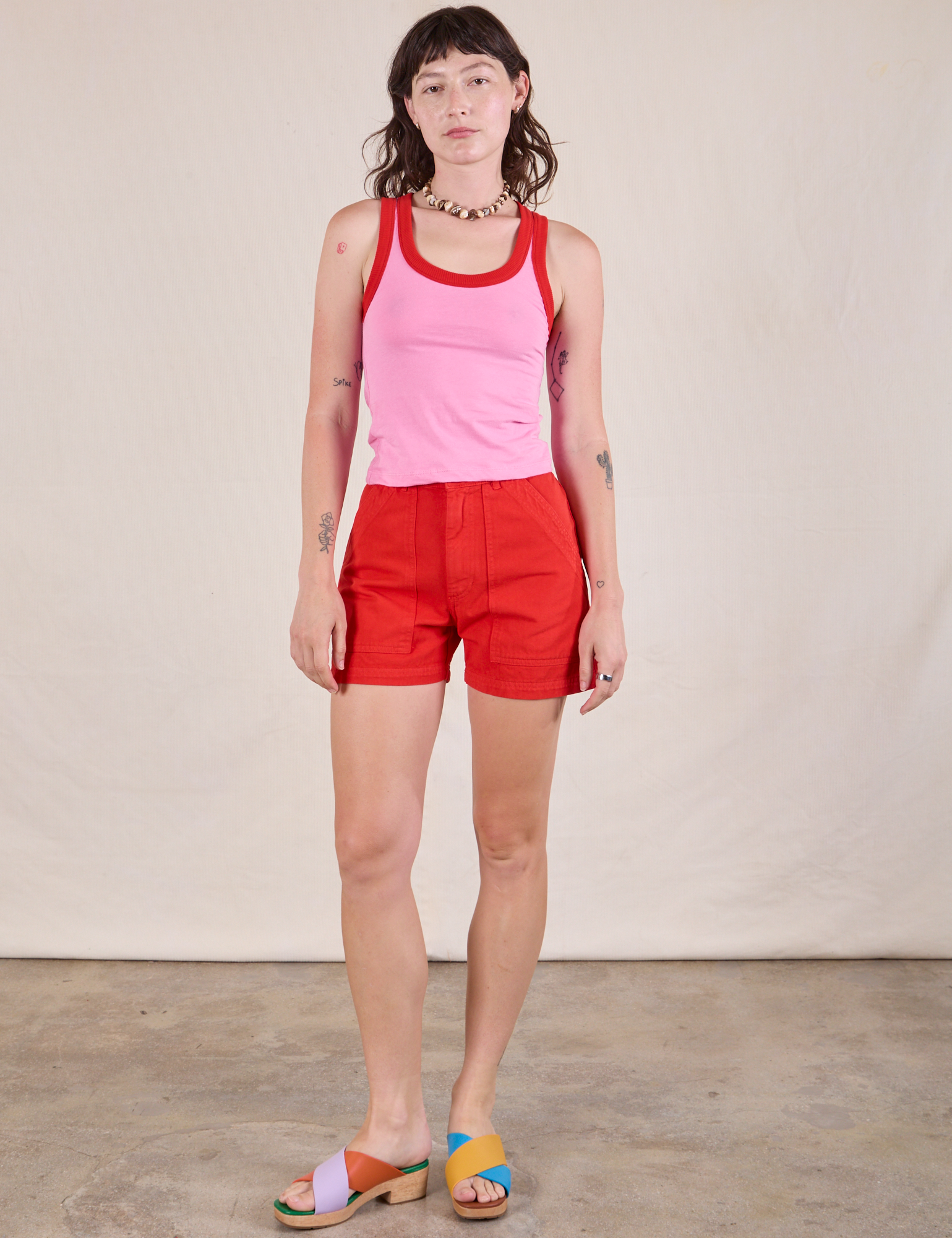 Alex is wearing Colorblock Cropped Tank in Bubblegum Pink and mustang red Western Shorts