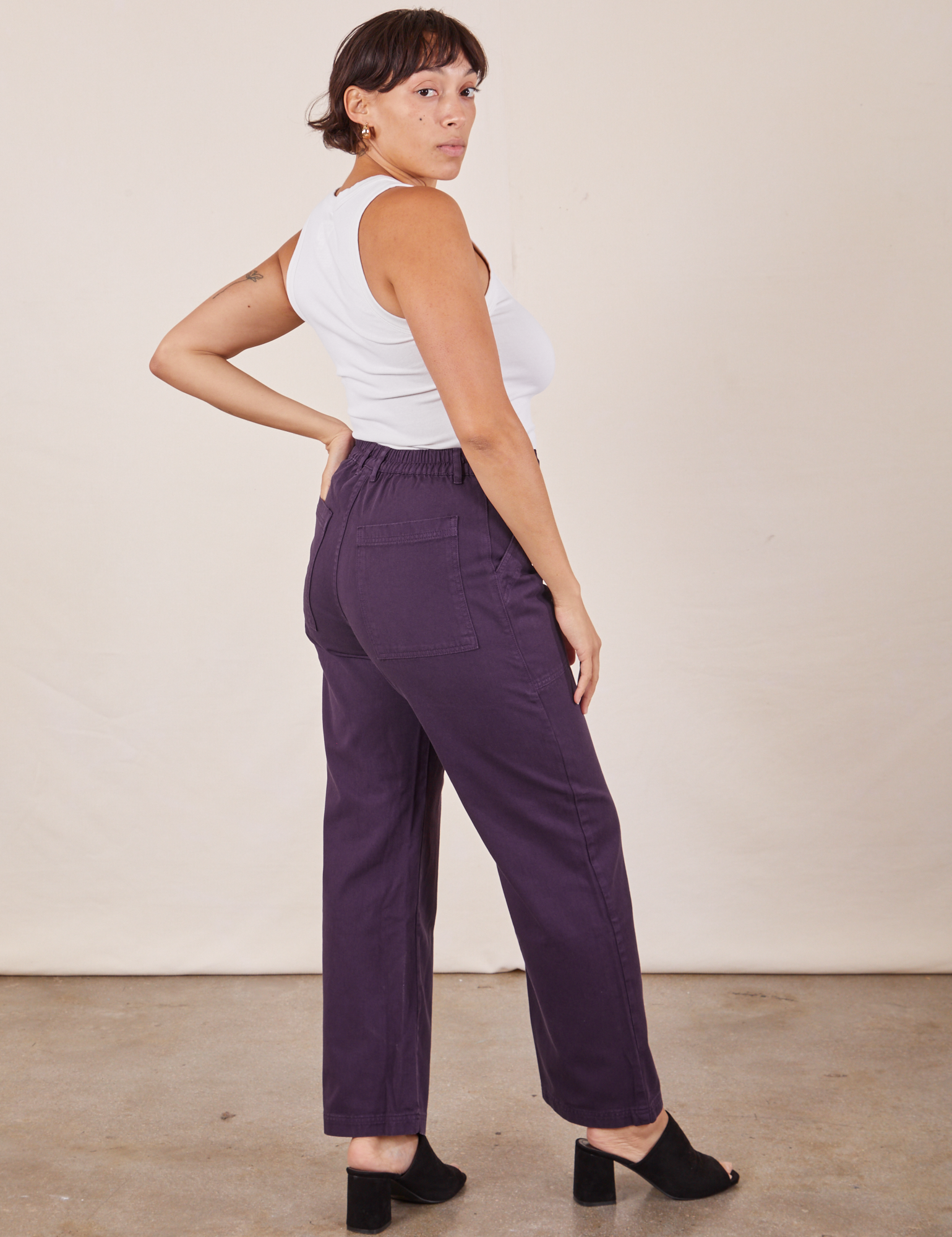 Angled back view of Work Pants in Nebula Purple worn by Tiara