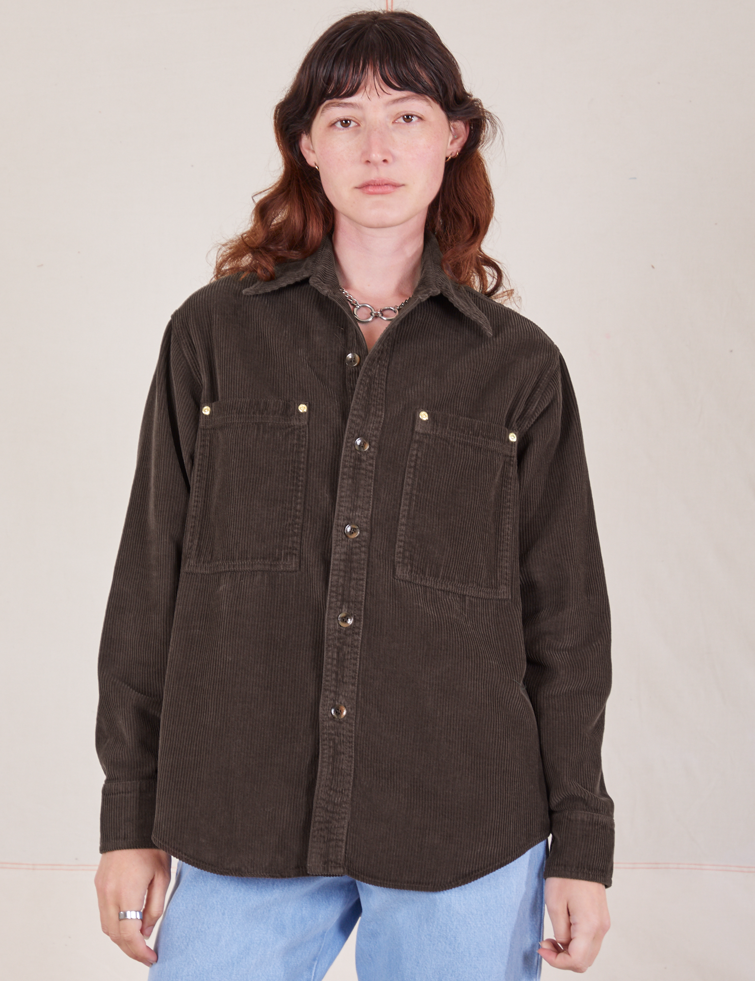 Alex is wearing a buttoned up Corduroy Overshirt in Espresso Brown
