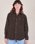 Alex is wearing a buttoned up Corduroy Overshirt in Espresso Brown