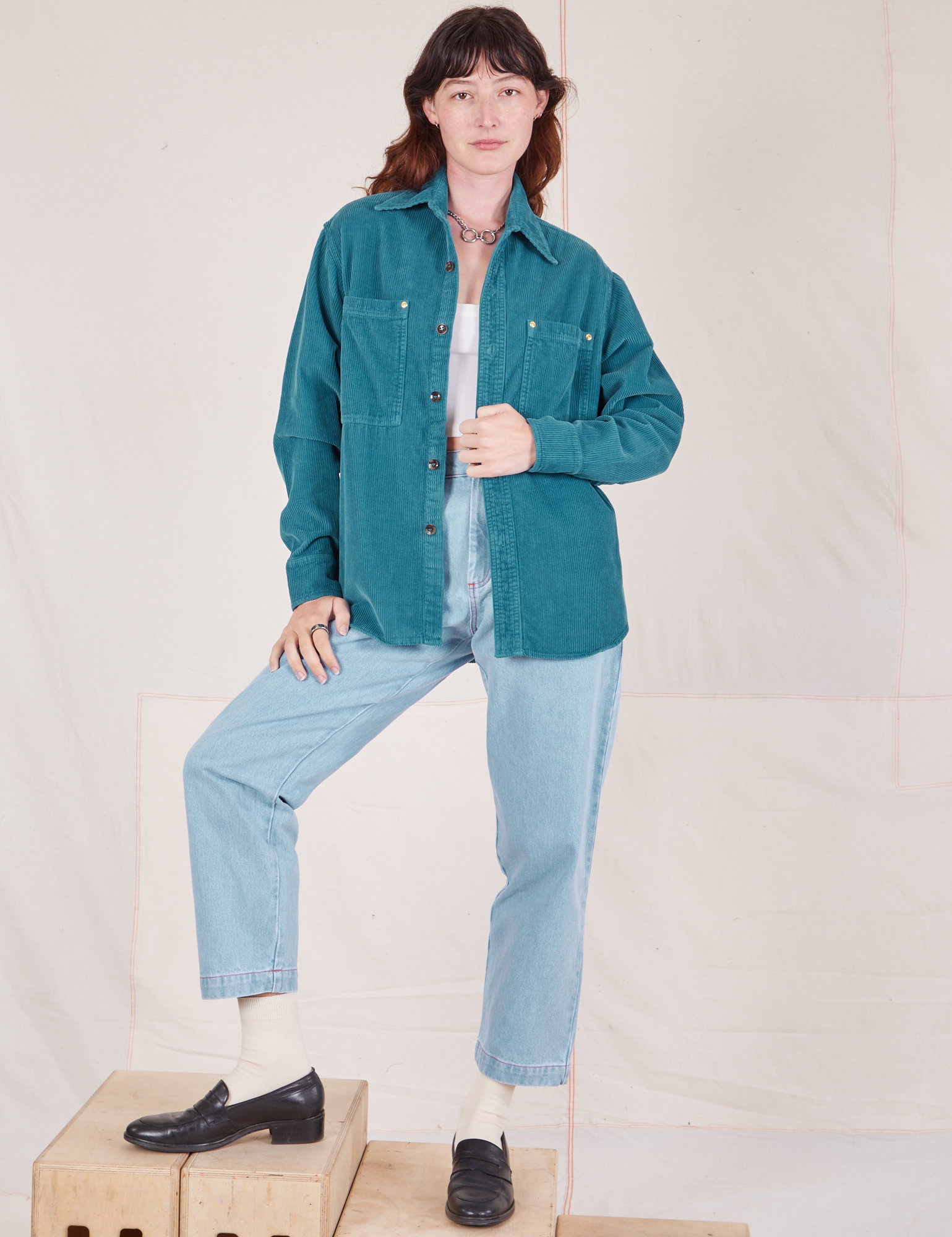 Alex is wearing Corduroy Overshirt in Marine Blue paired with light wash Denim Trouser Jeans