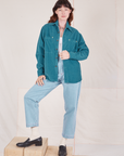 Alex is wearing Corduroy Overshirt in Marine Blue paired with light wash Denim Trouser Jeans