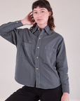 Alex is wearing a buttoned up Cropped Overshirt in Slate Grey