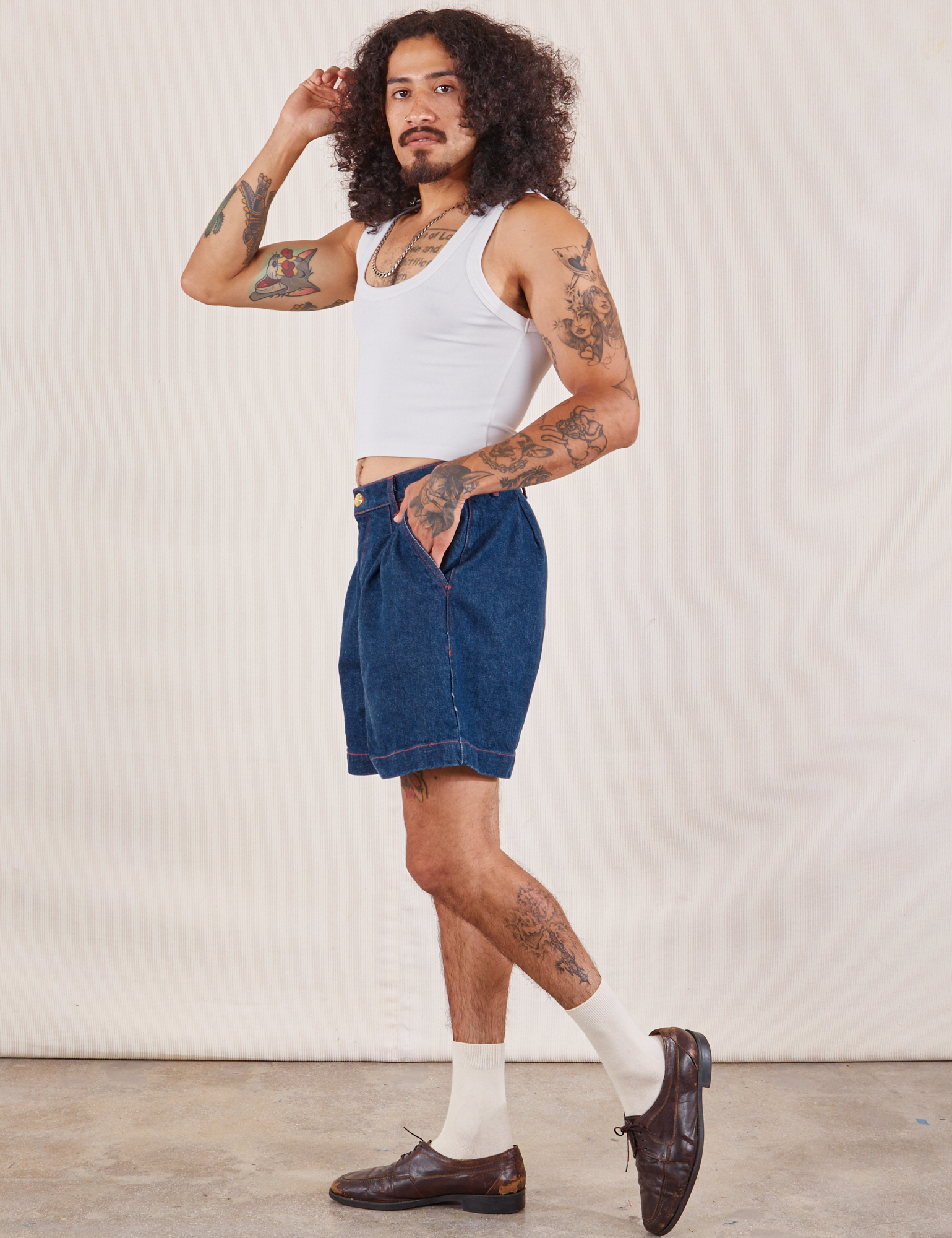 Side view of Denim Trouser Shorts in Dark Wash and Cropped Tank in vintage tee off-white on Jesse