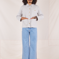Jesse is wearing a buttoned up Denim Work Jacket in Dishwater White paired with light wash Sailor Jeans
