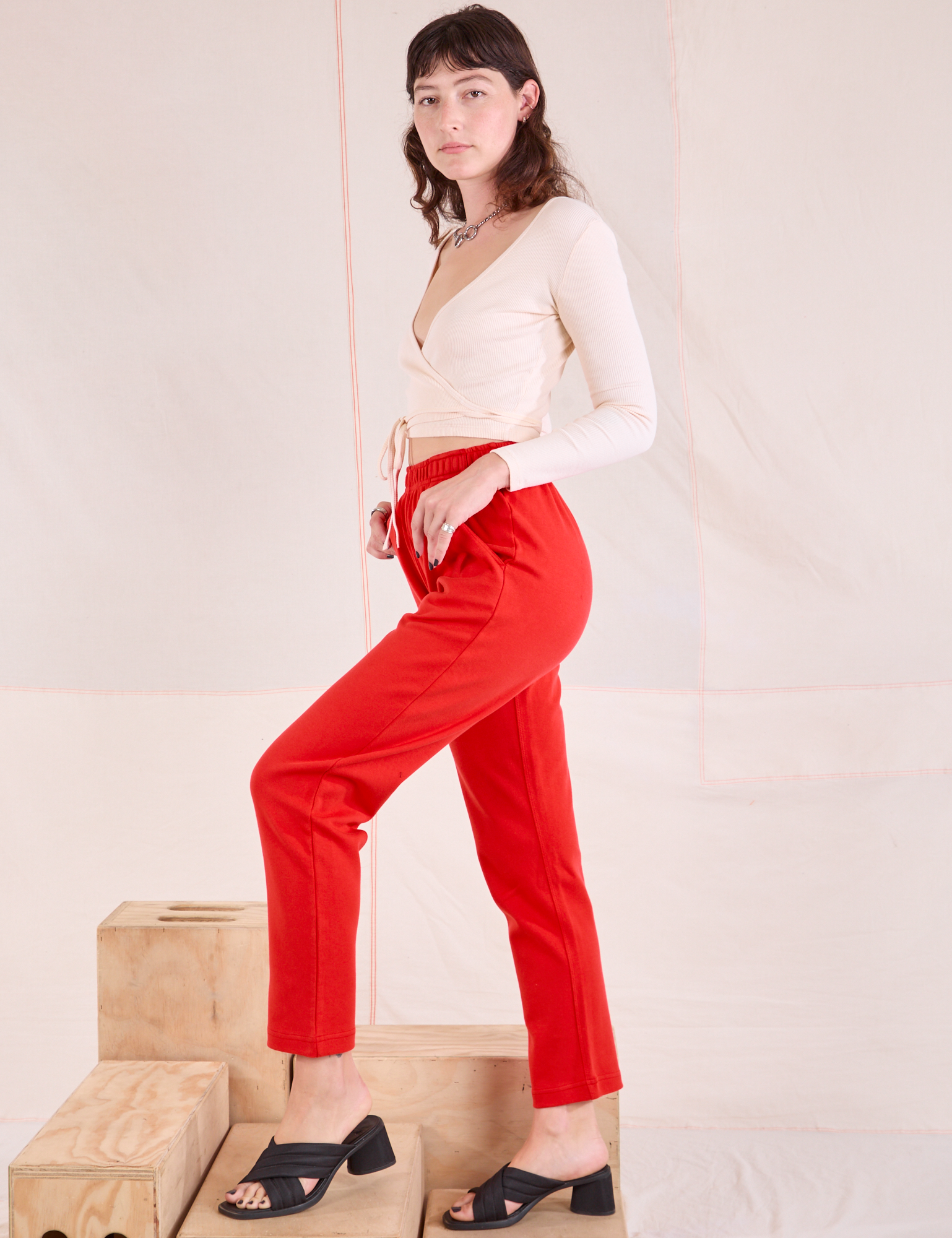 Side view of Easy Pants in Mustang Red and vintage tee off-white Wrap Top on Alex