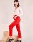 Side view of Easy Pants in Mustang Red and vintage tee off-white Wrap Top on Alex