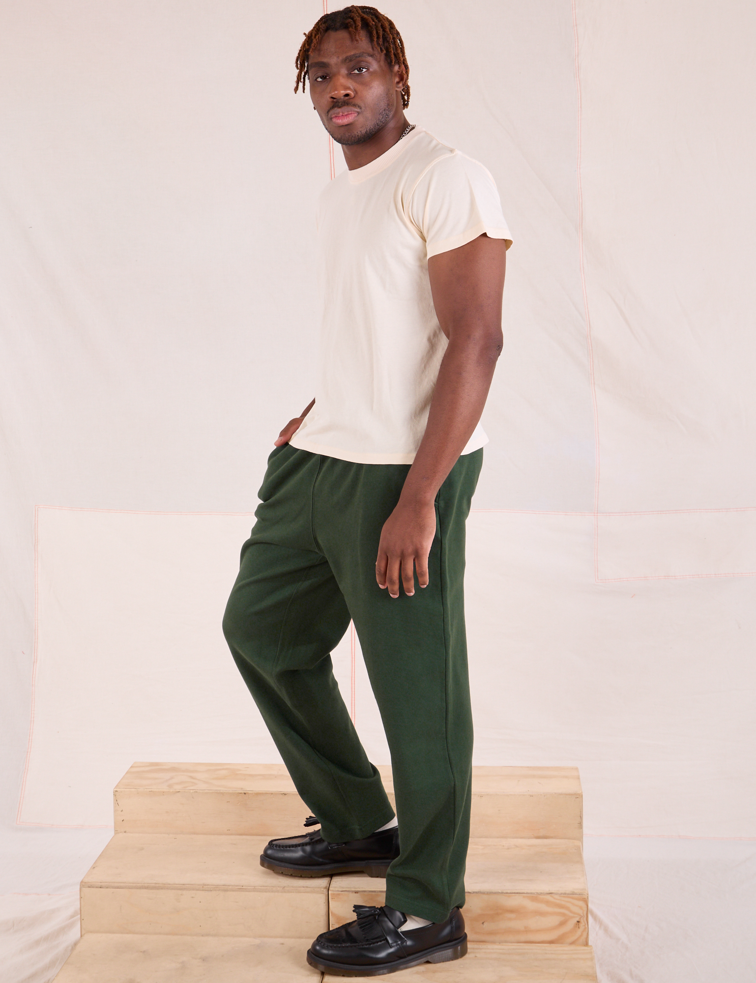 Side view of Easy Pants in Swamp Green and Organic Vintage Tee in Vintage Tee Off-White on Issac