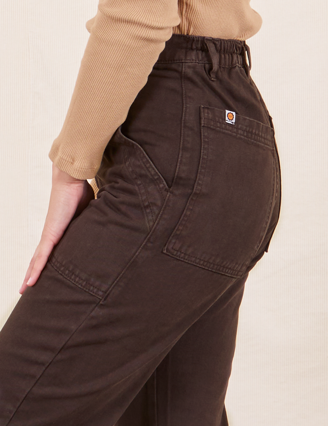 Side close up of Work Pants in Espresso Brown worn by Soraya