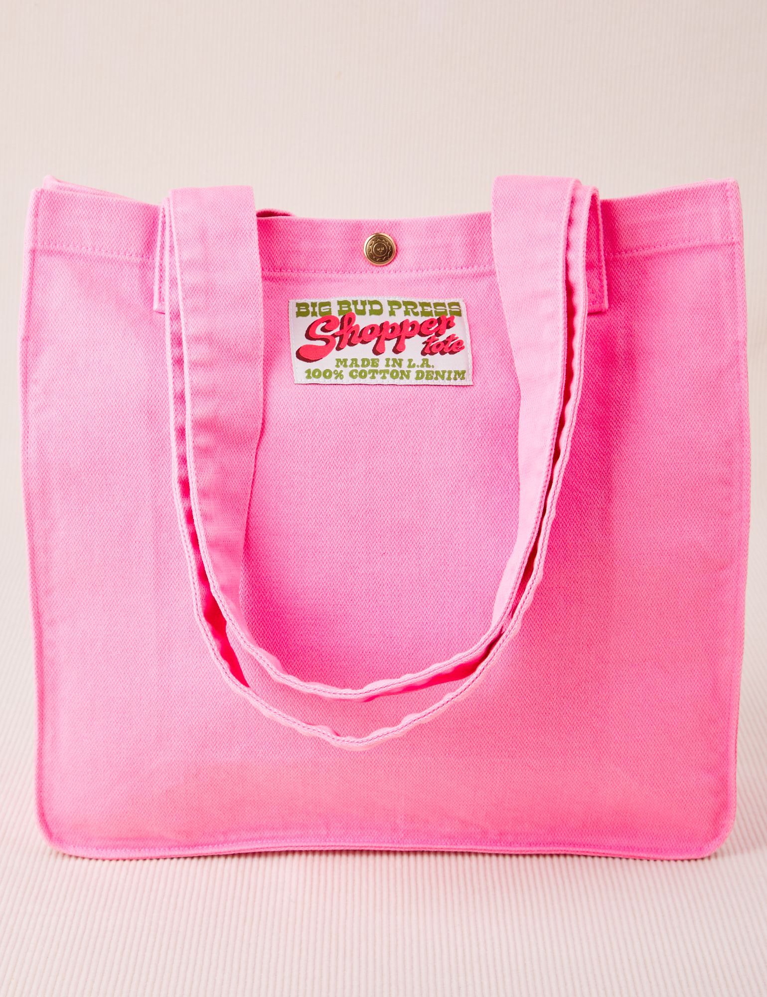 Shopper Tote Bag in Bubblegum pink with straps laying on front of bag