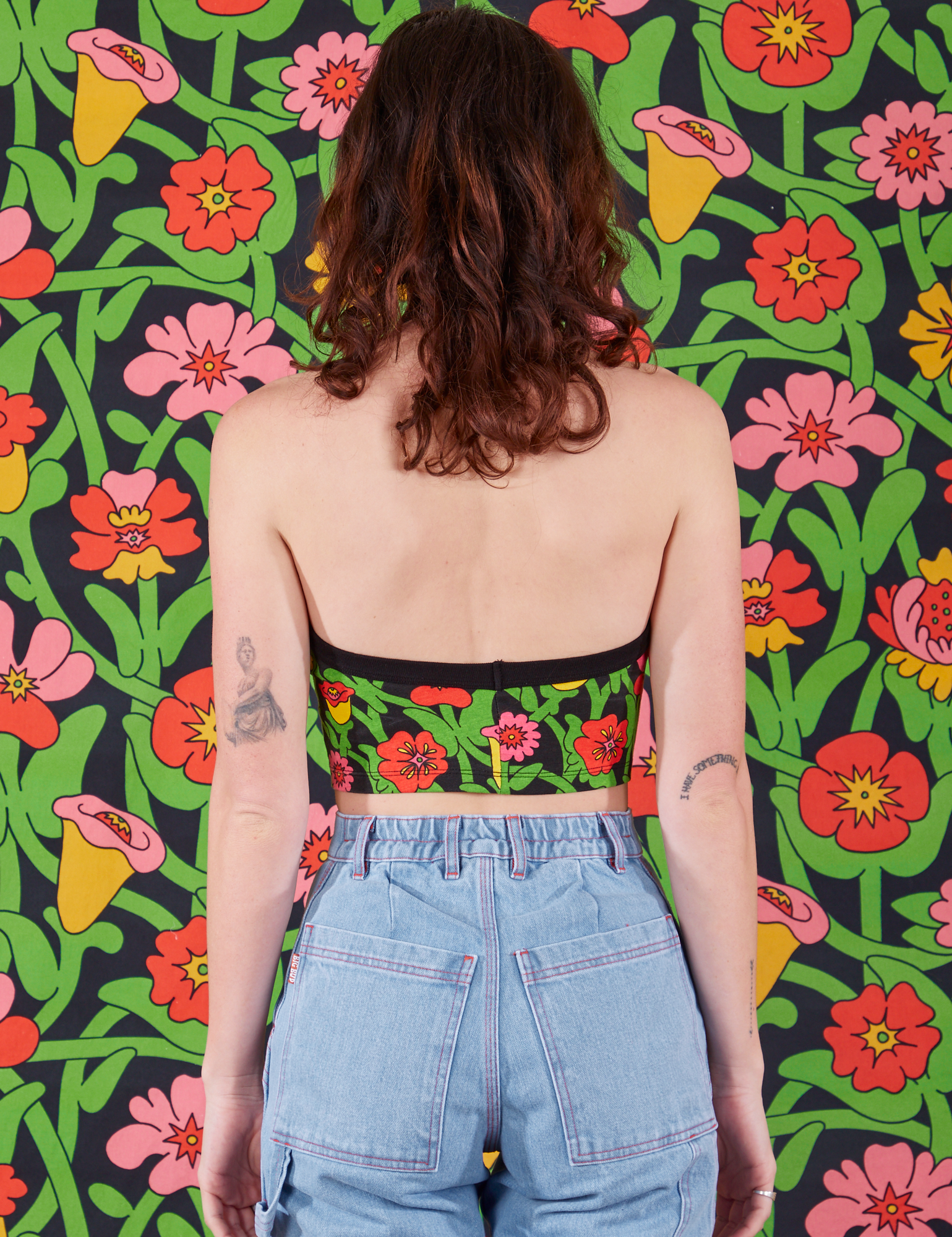 Back view of Halter Top in Flower Tangle and light wash Carpenter Jeans on Alex