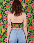 Back view of Halter Top in Flower Tangle and light wash Carpenter Jeans on Alex