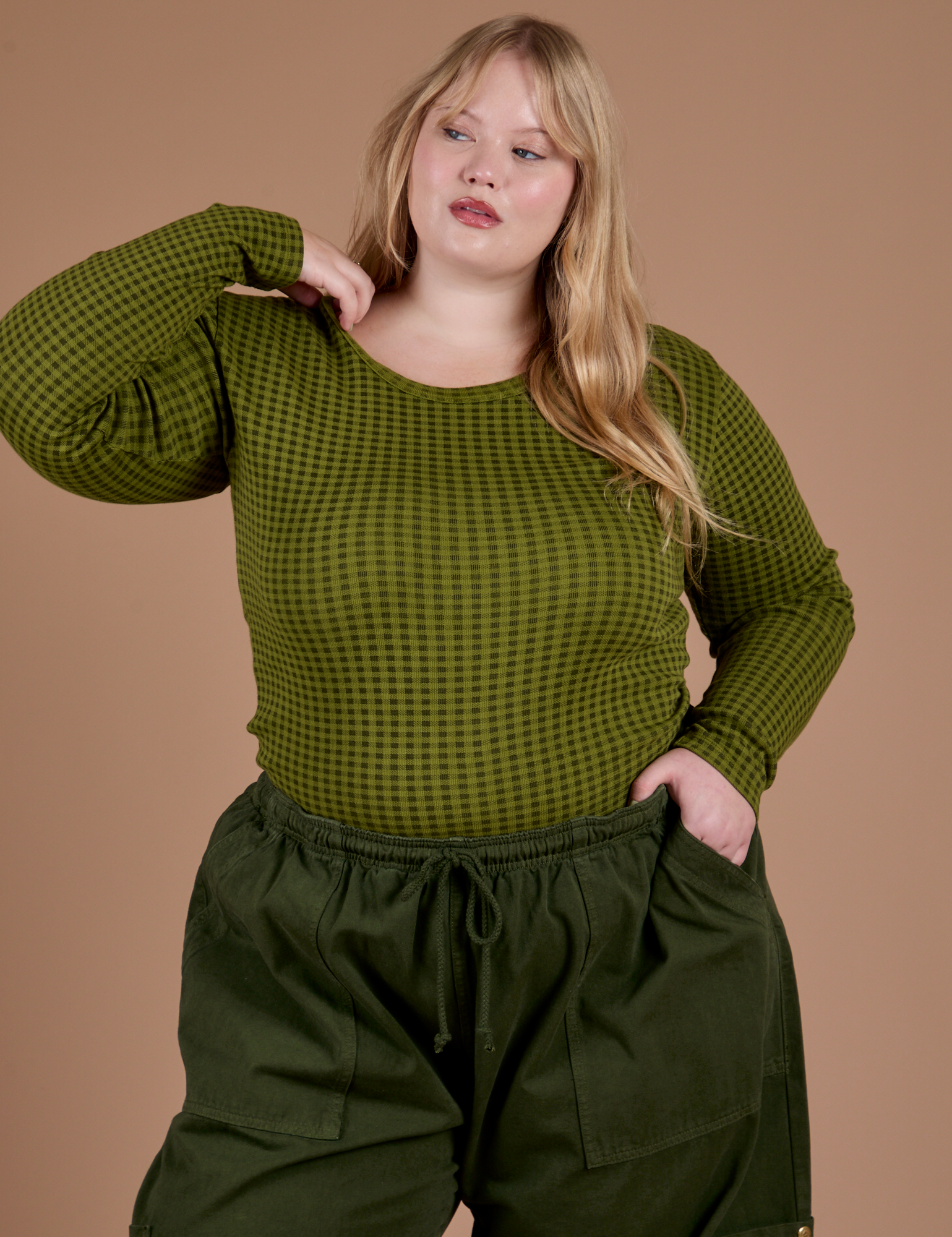 Juliet is wearing Gingham Long Sleeve Baby Tee in Summer Olive 