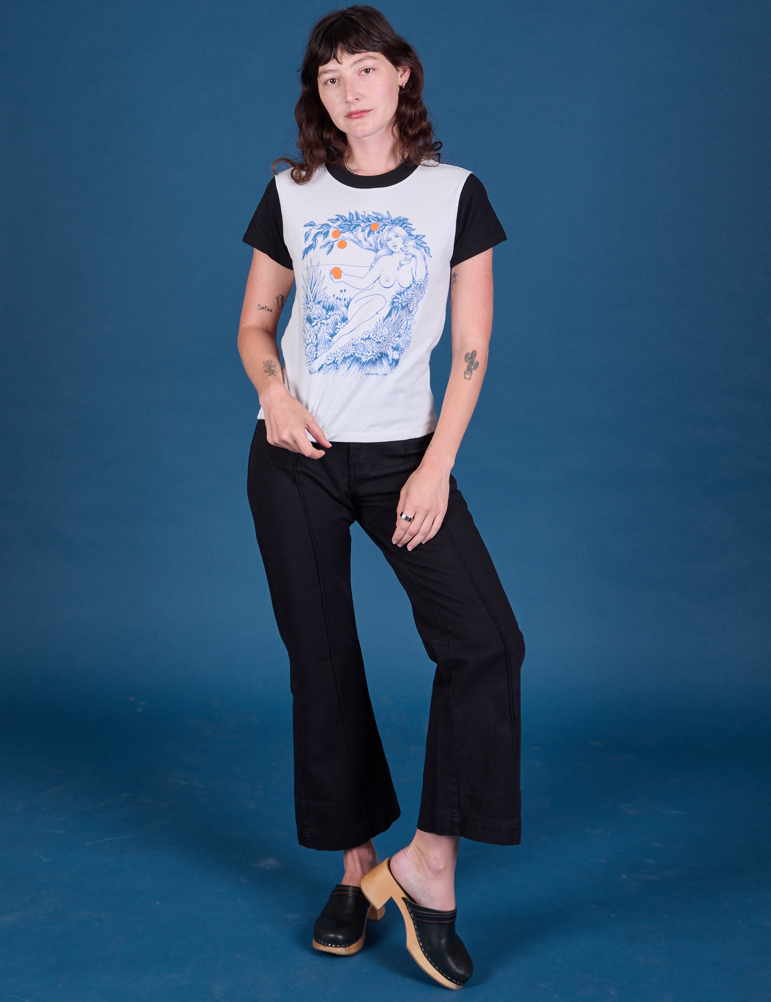 Alex is wearing Vintage Tee in California Girl paired with black Western Pants