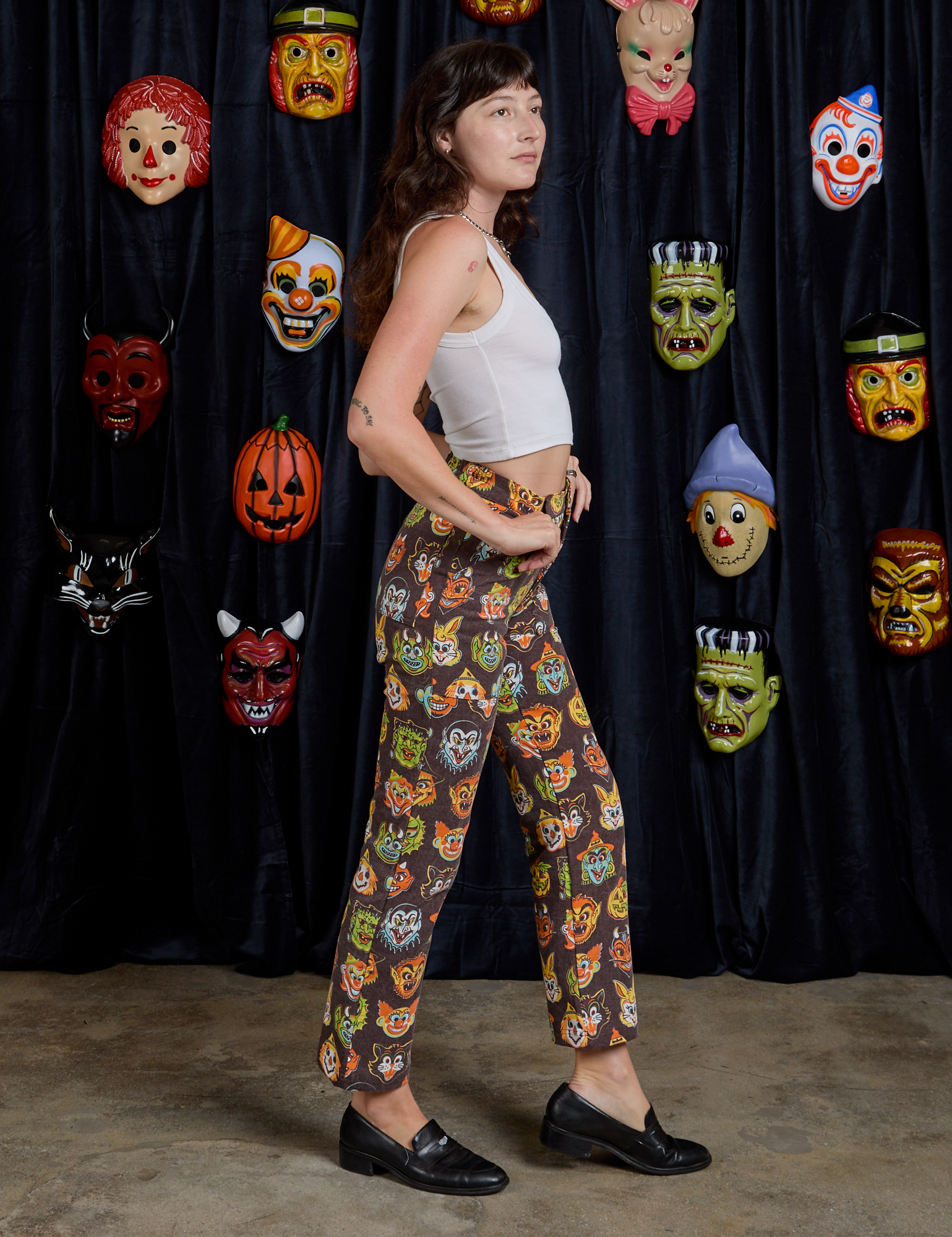 Side view of Work Pants in Halloween Masks and Cropped Tank in Vintage Tee White on Alex