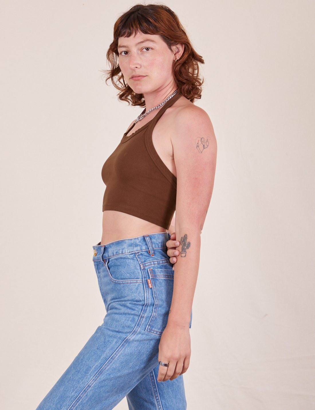 Side view of Halter Top in Fudgesicle Brown and light wash Frontier Jeans worn by Alex