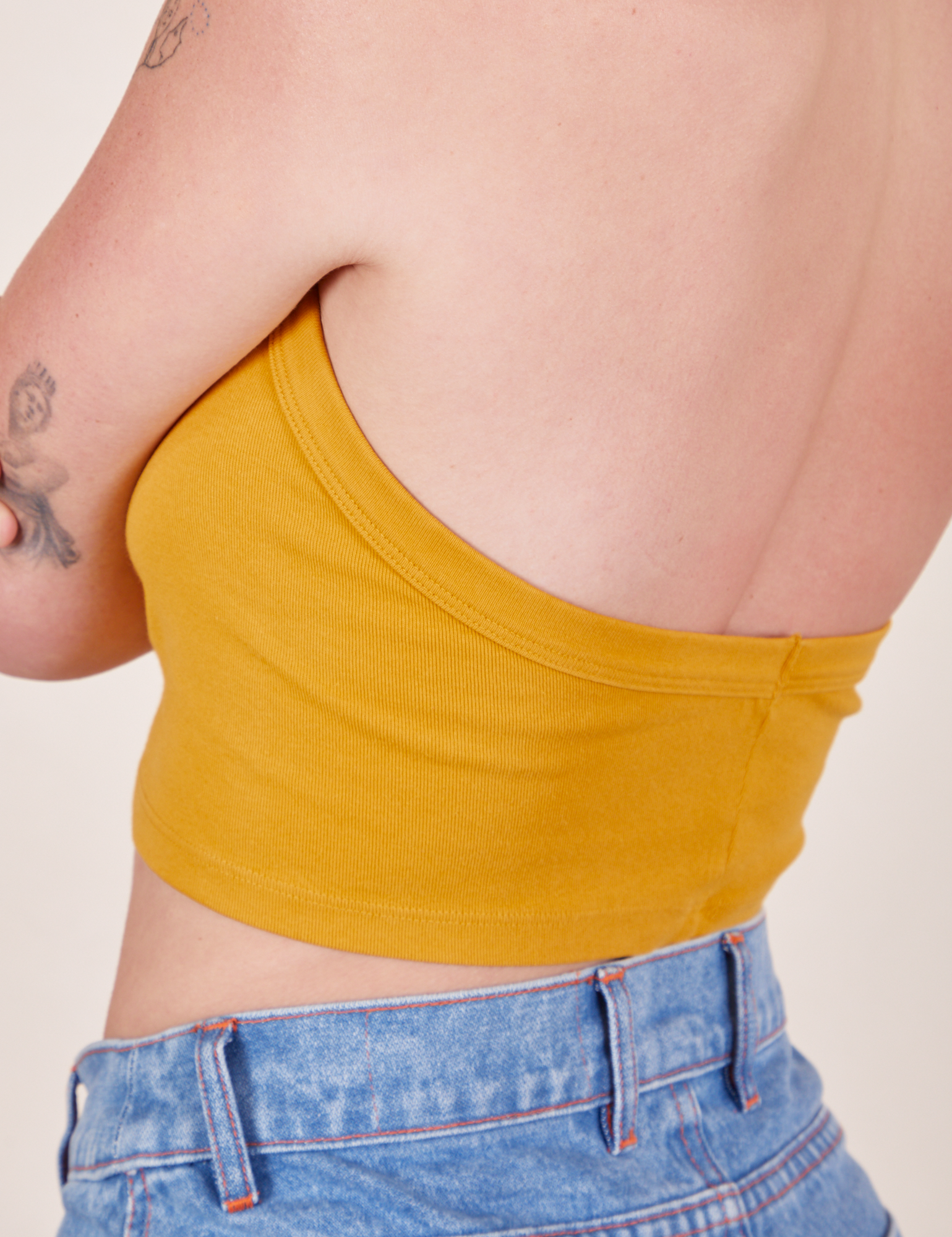 Back close up of Halter Top in Mustard Yellow worn by Alex