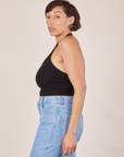 Side view of Halter Top in Basic Black and light wash Sailor Jeans worn by Tiara