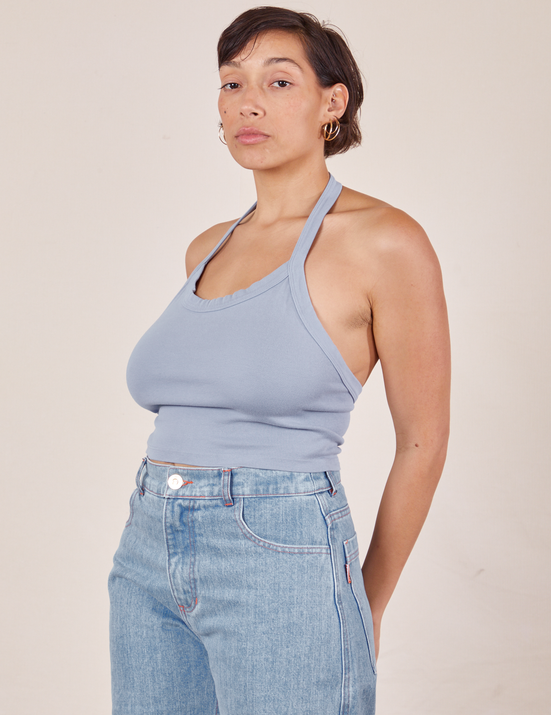 Tiara is wearing Halter Top in Periwinkle and light wash Sailor Jeans