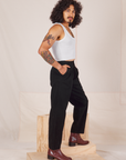 Side view of Heavyweight Trousers in Basic Black and vintage off-white Cropped Tank Top worn by Jesse