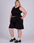 Angled front view of Pleated Trouser Shorts in Basic Black and black Racerback Tank