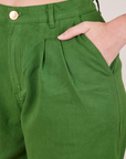 Front close up of Heavyweight Trousers in Lawn Green. Alex has her hand in the pocket.