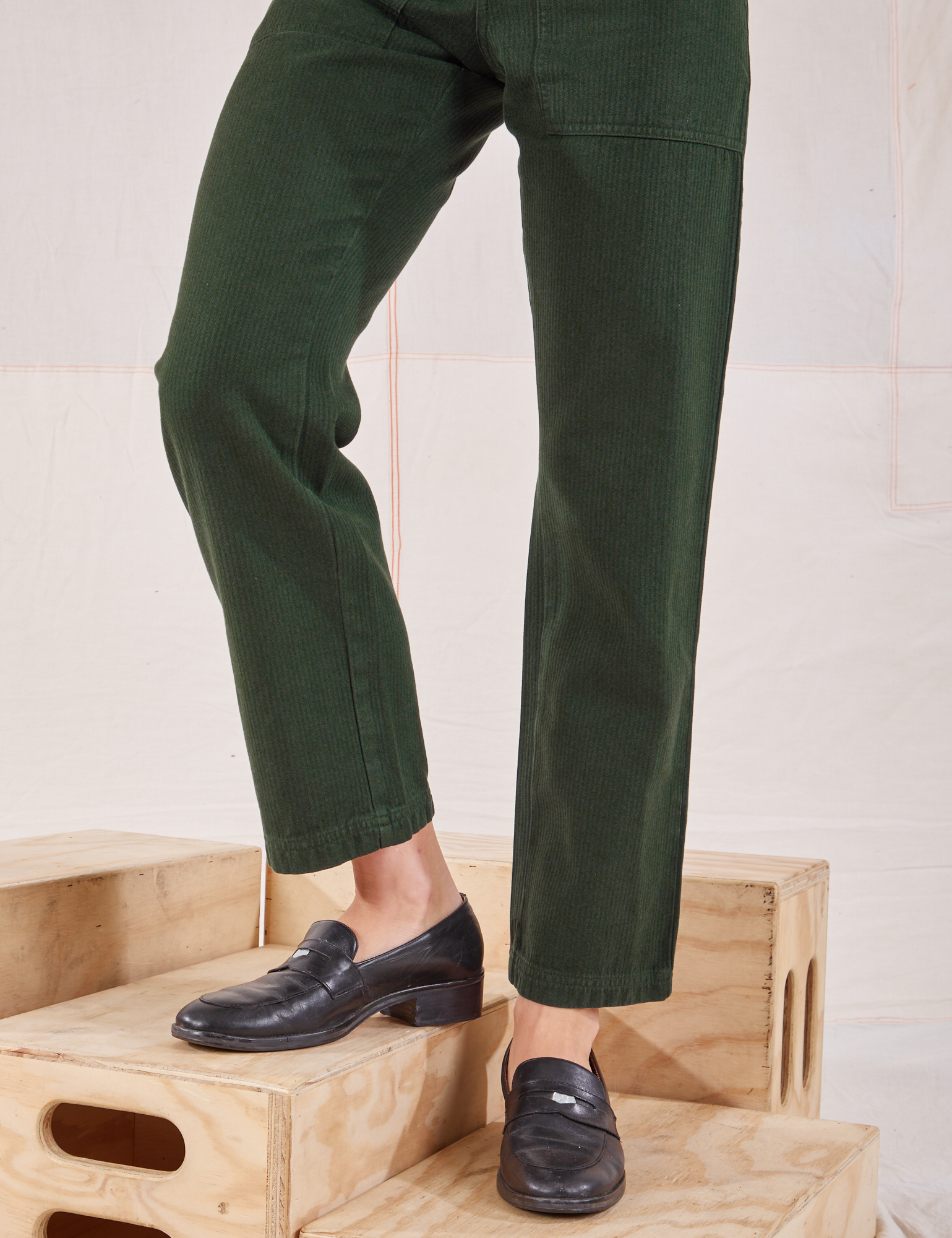 Heritage Short Sleeve Jumpsuit in Swamp Green pant leg close up on Alex