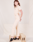 Side view of Heritage Short Sleeve Jumpsuit in Natural worn by Alex