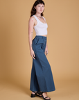 Side view of Heritage Wide Leg Trousers in French Blue and vintage tee white Cropped Tank on Alex
