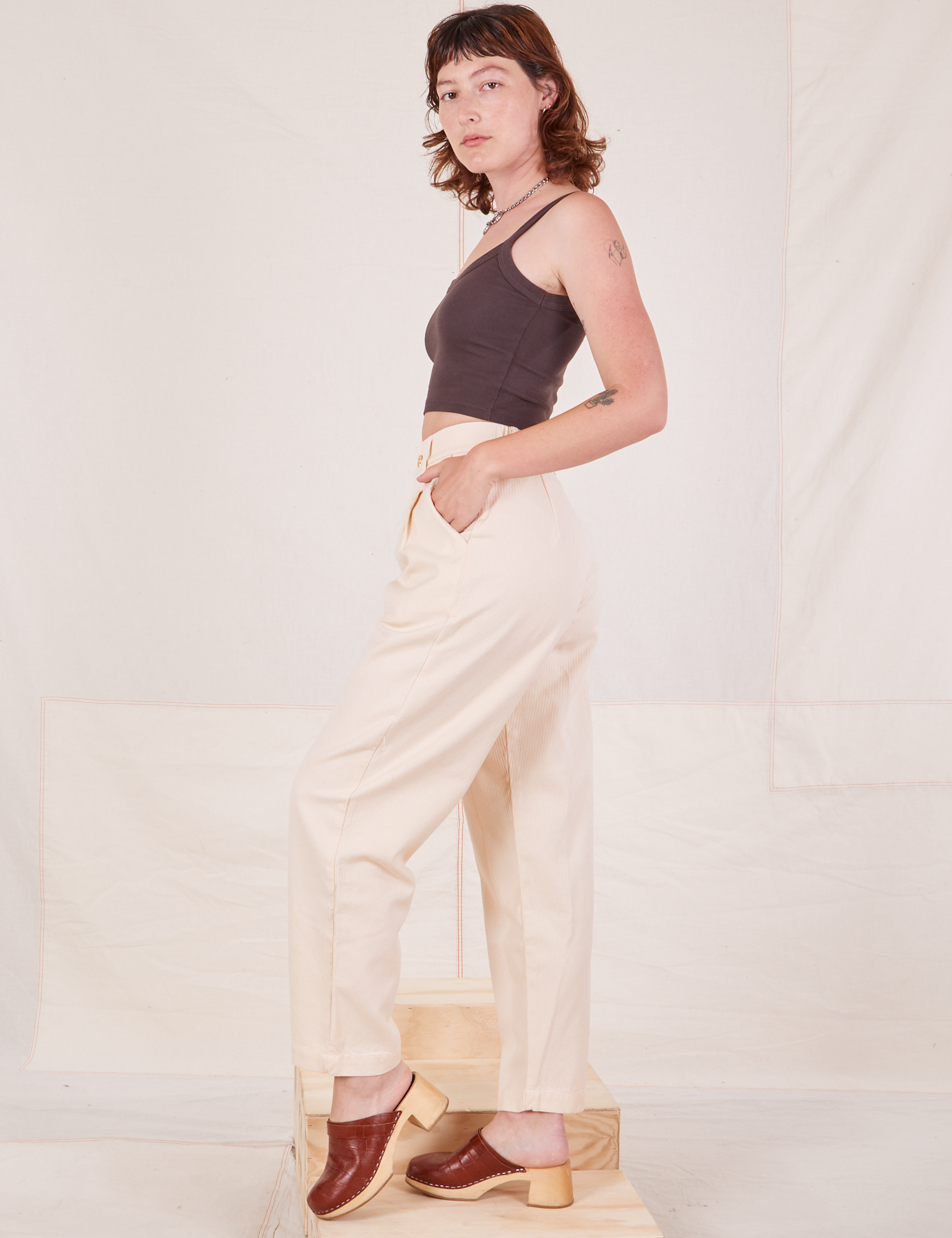 Side view of Heritage Trousers in Vintage Off-White and espresso brown Cropped Cami worn by Alex