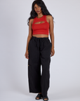 Kandia is wearing Porthole Tank in Mustang Red and Black Drop Pocket Cargo Pants