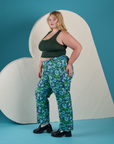 Side view of Work Pants in Angel Print and swamp green Cropped Tank on Juliet