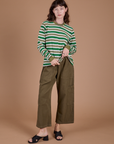 Alex is wearing Long Sleeve Striped Burly Tee in Green and Drop Pocket Cargo Pants in Surplus Green
