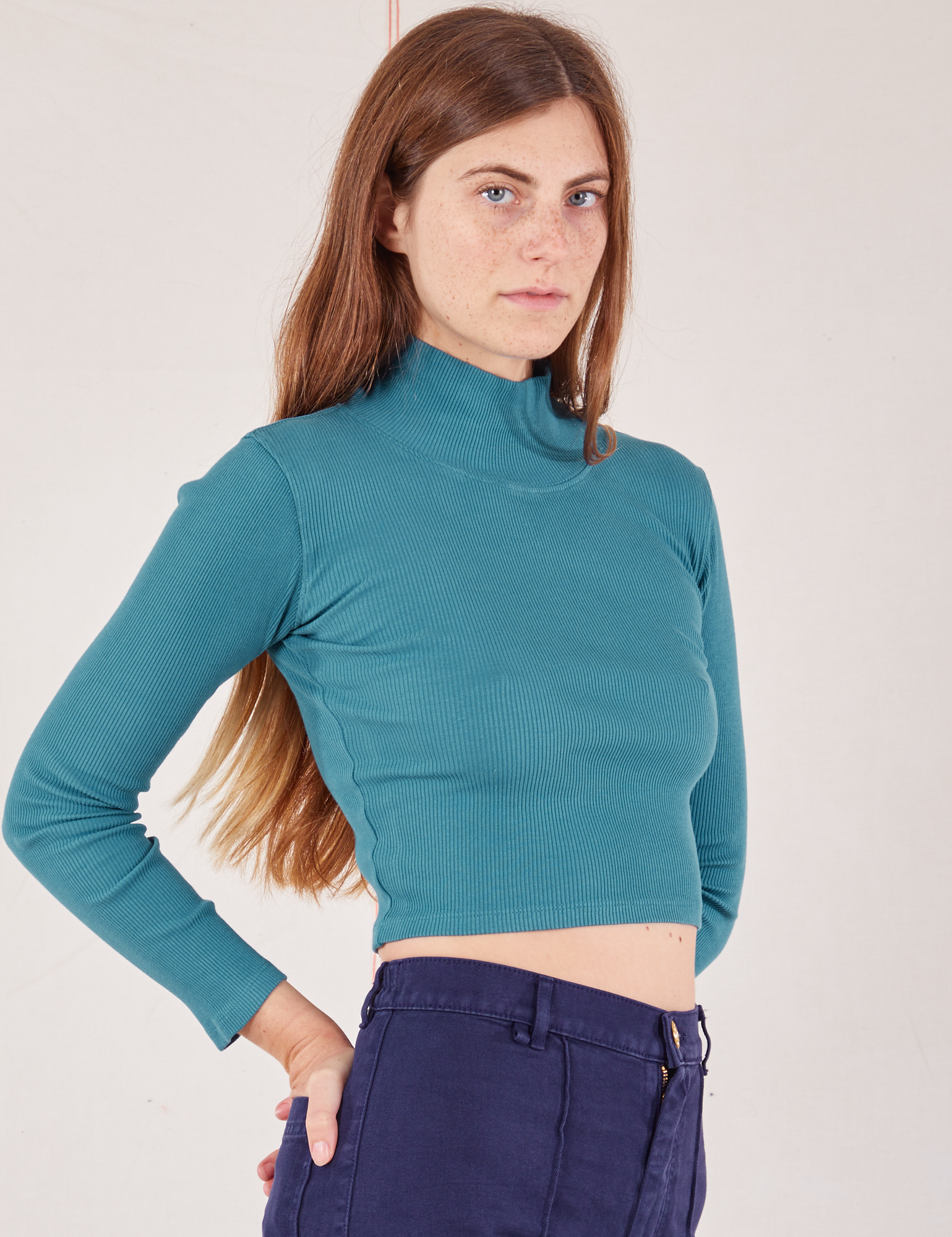Essential Turtleneck in Marine Blue angled front view of Scarlett