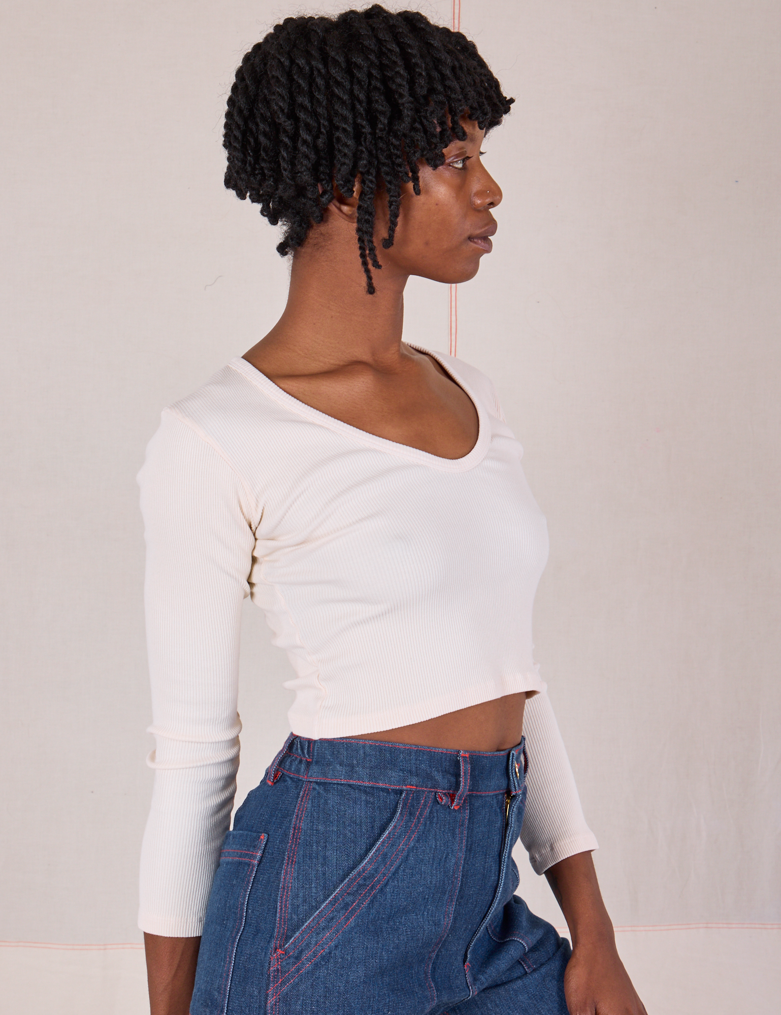 Angled front view of Long Sleeve V-Neck Tee in Vintage Tee Off-White on Cheyann