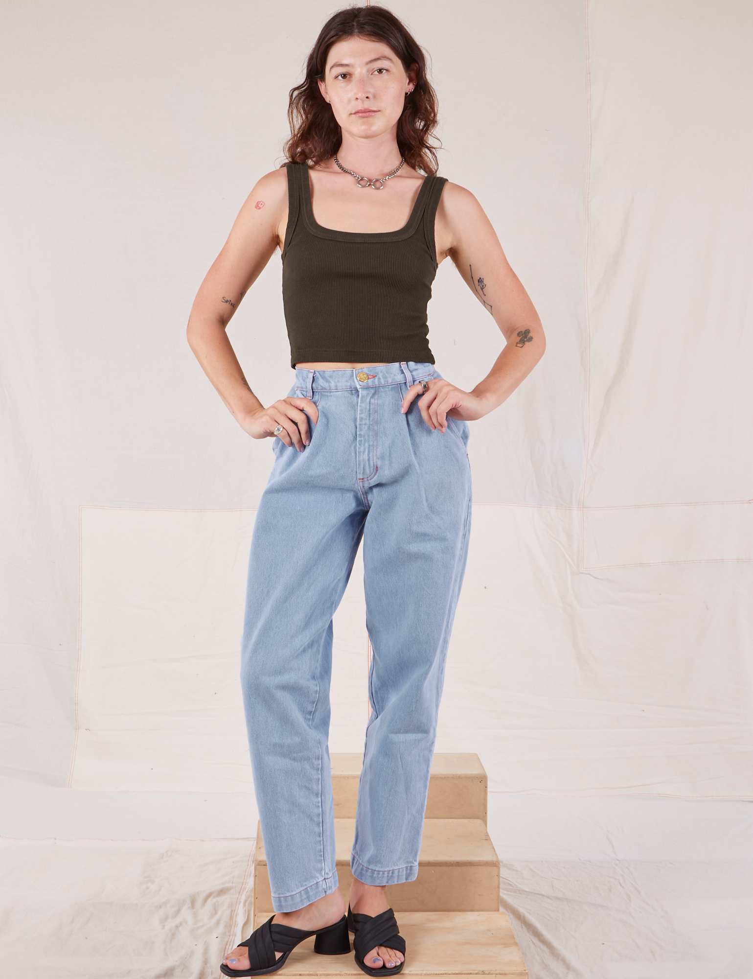 Alex is wearing Square Neck Tank in Espresso Brown and light wash Denim Trousers