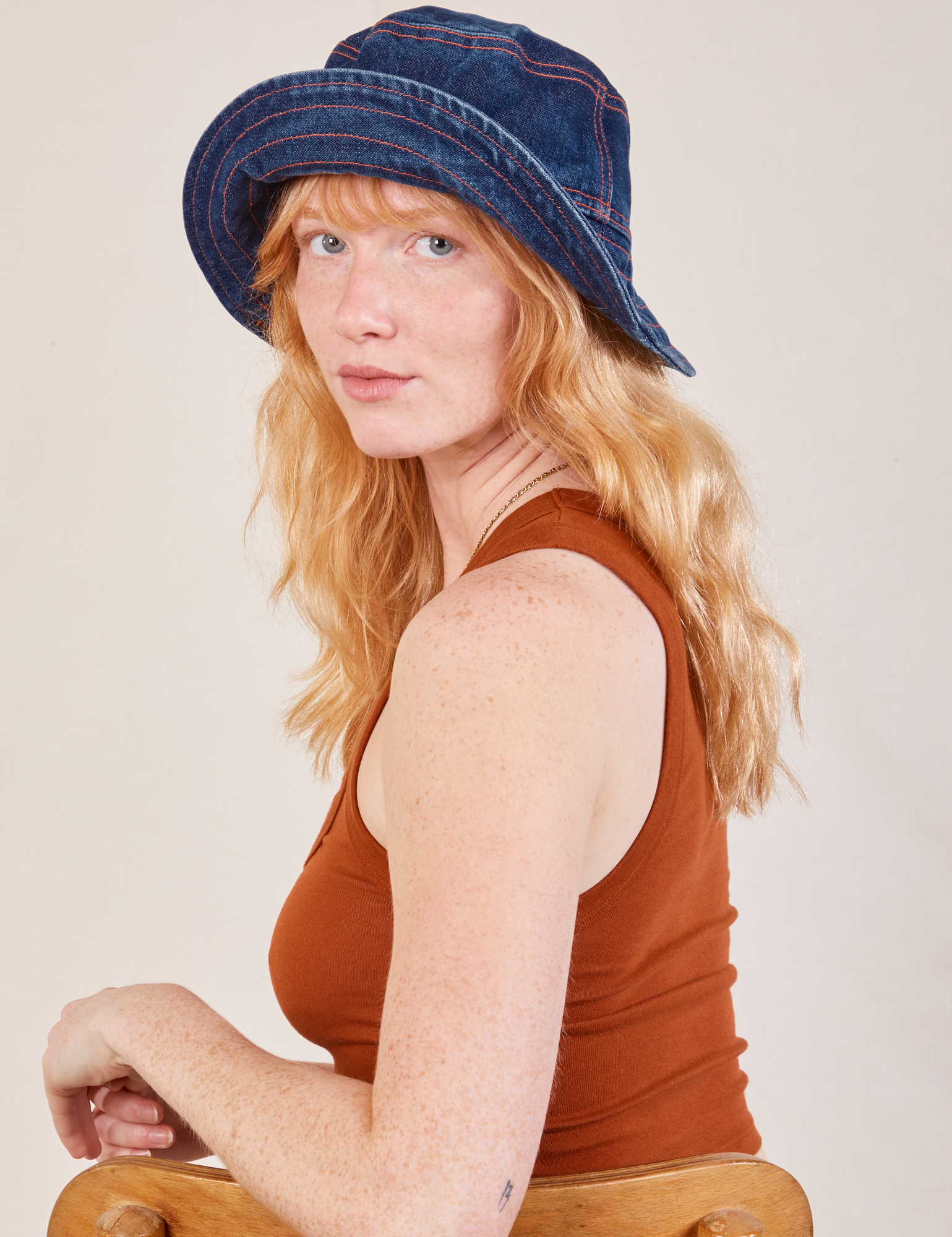 Margaret is wearing the Wide Brim Denim Bucket Hat in dark wash